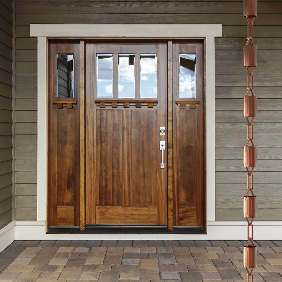 Copper rain chain beside a craftsman front door
